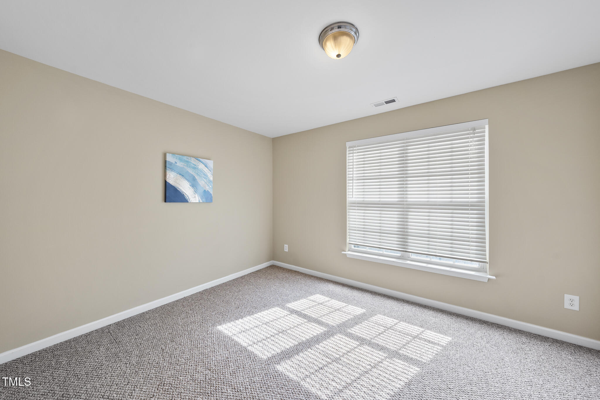 9910 Clyborn Court Raleigh, NC 27617 - Photo 4 of 19 a view of an empty room with a window
