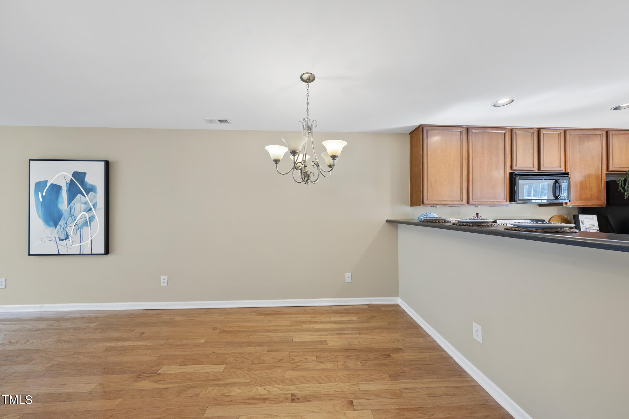 9910 Clyborn Court Raleigh, NC 27617 - Photo 9 of 19 a view of a kitchen with microwave and cabinets