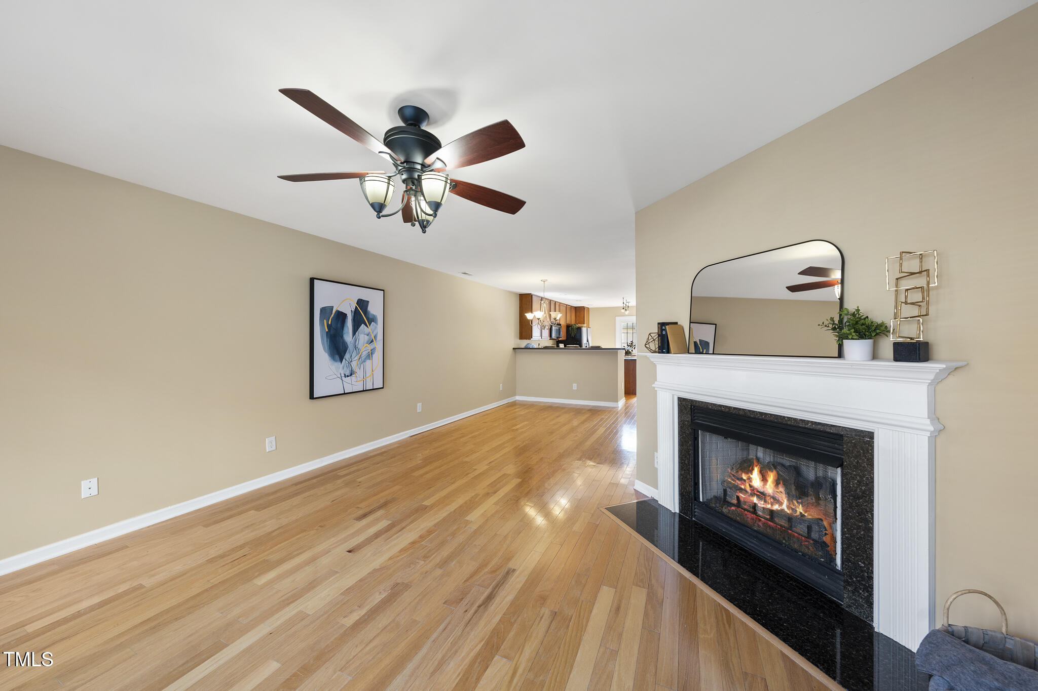 9910 Clyborn Court Raleigh, NC 27617 - Photo 10 of 19 a view of a livingroom with a fireplace a ceiling fan and a fireplace