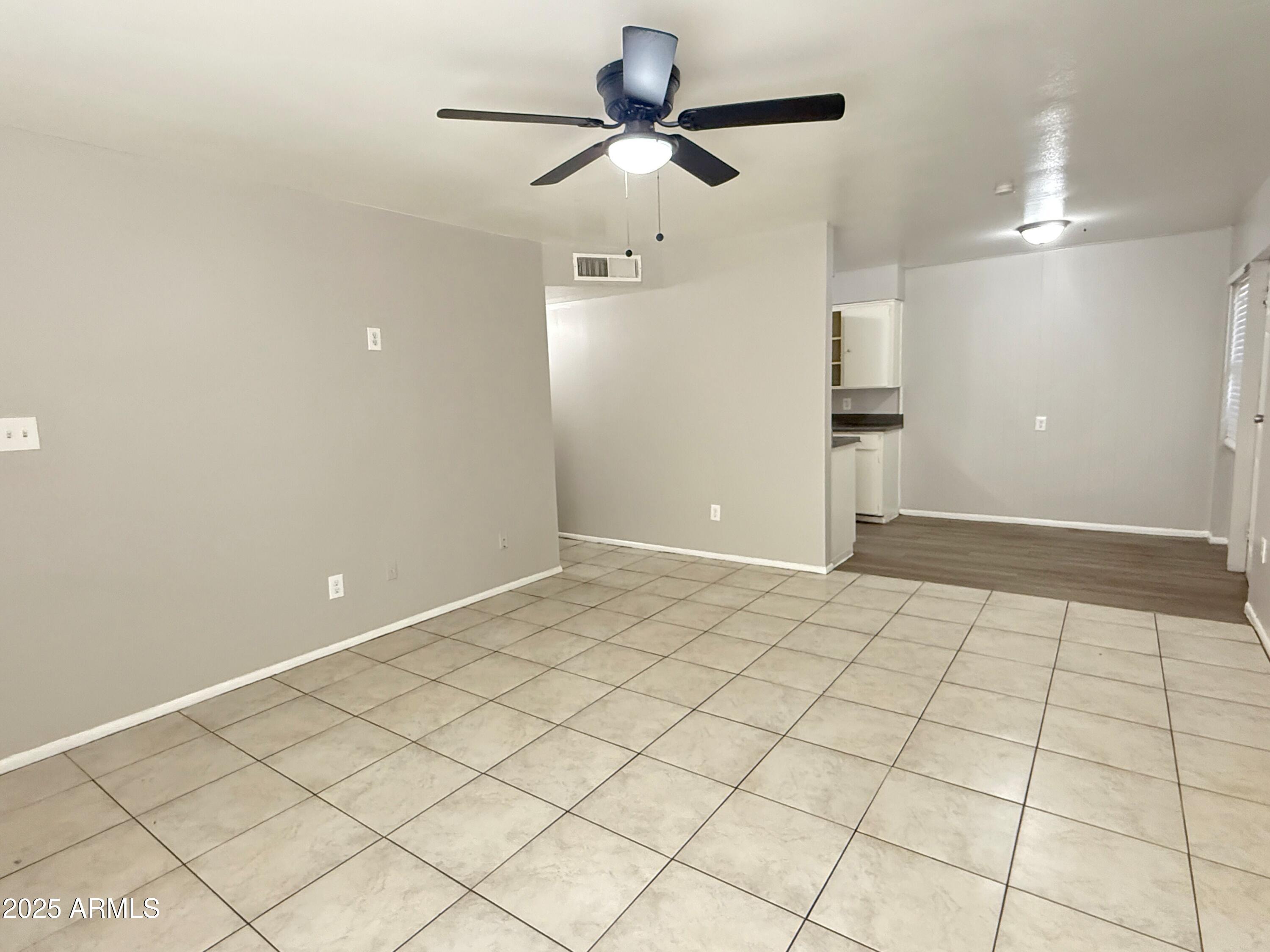 4719 North 15th Avenue, Unit 3 Phoenix, AZ 85015 - Photo 4 of 12 a view of an empty room and chandelier fan