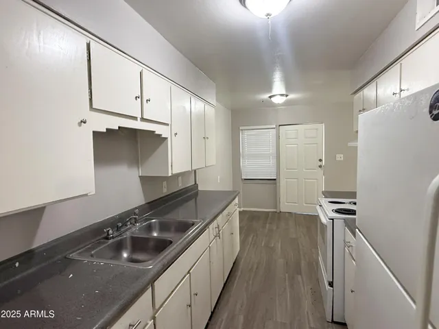a kitchen with stainless steel appliances a sink a stove and a refrigerator