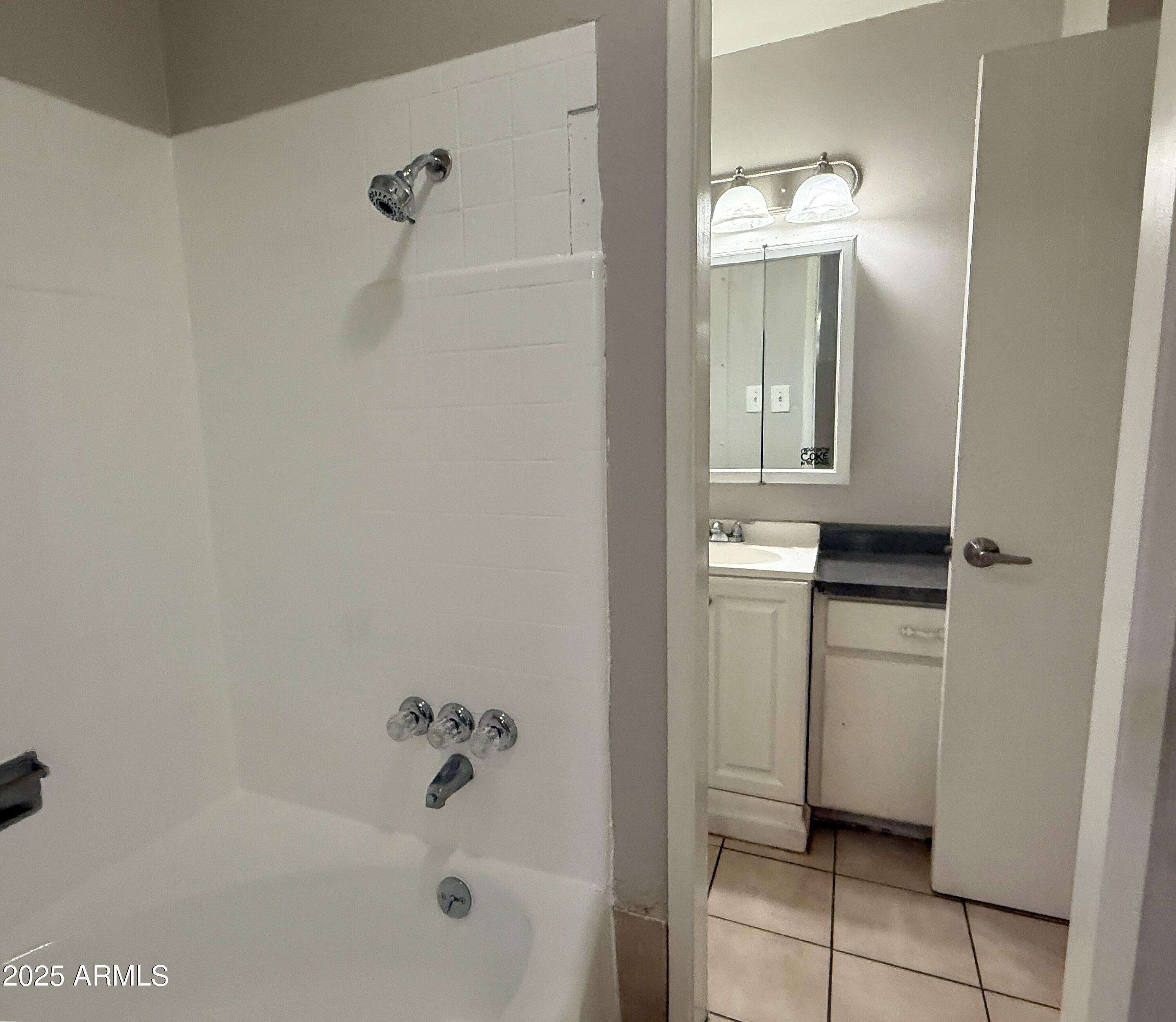 4719 North 15th Avenue, Unit 3 Phoenix, AZ 85015 - Photo 10 of 12 a bathroom with a bathtub and a shower