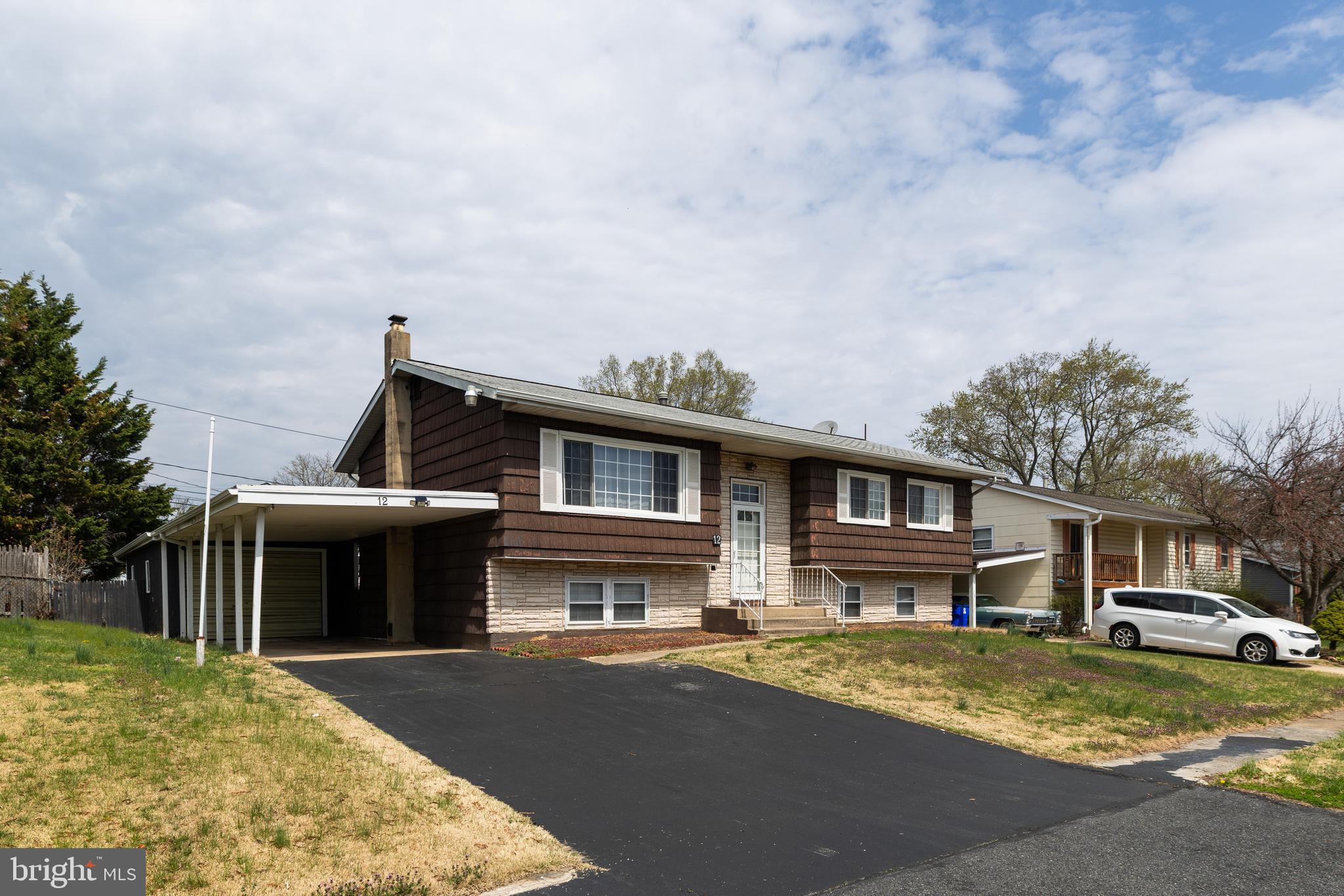 a front view of a house with a garden and deck