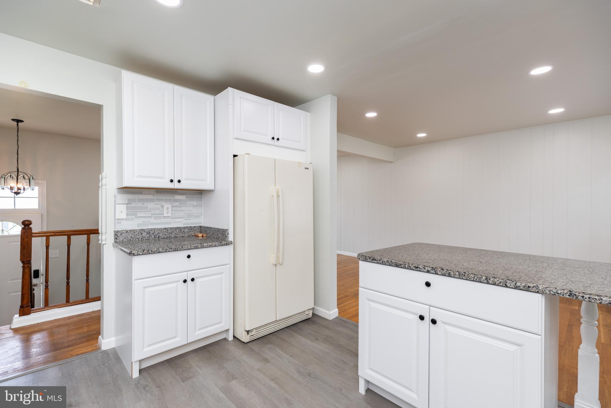 12 Alwyn Road Newark, DE 19713 - Photo 13 of 31 a kitchen with granite countertop white cabinets and stainless steel appliances
