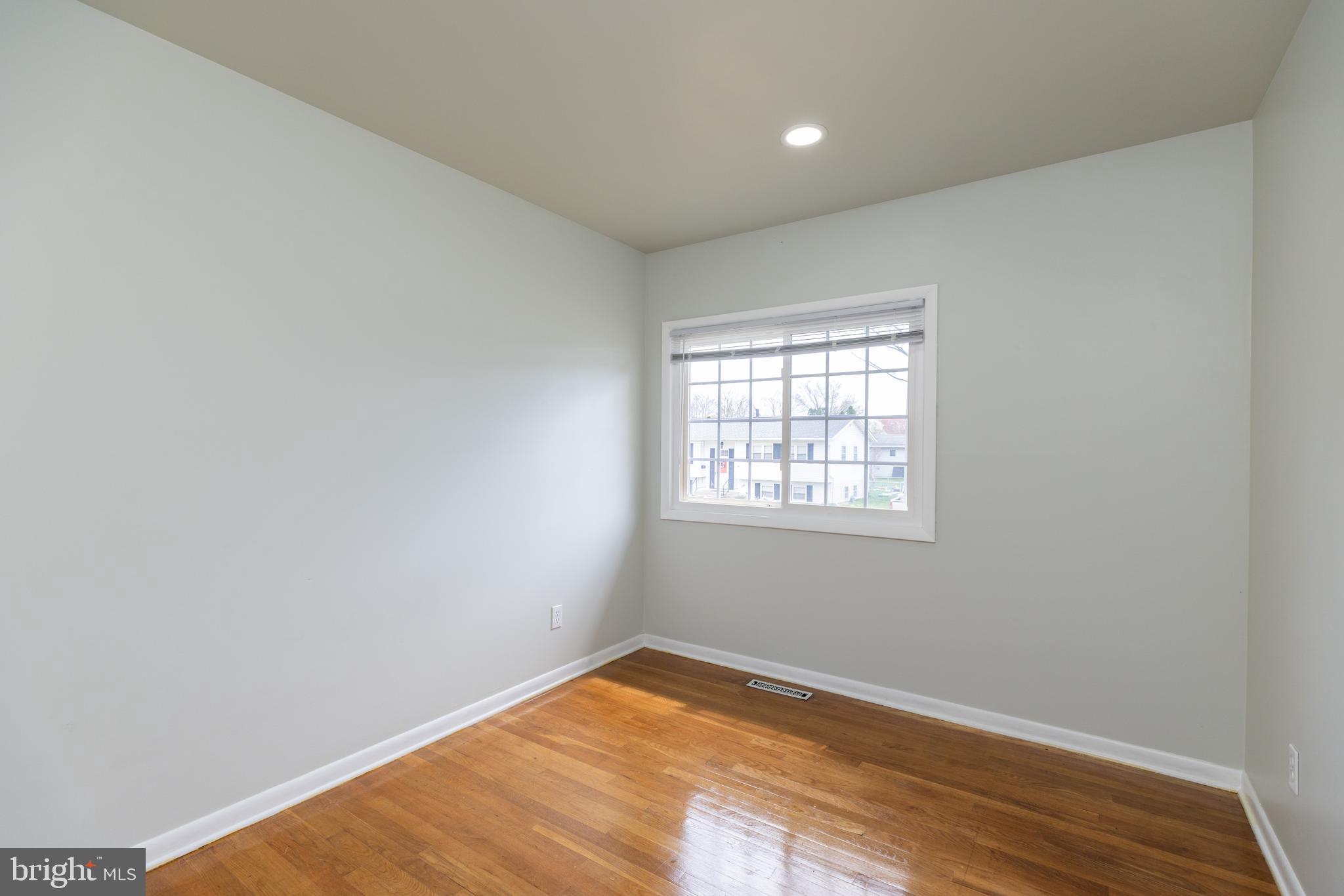 12 Alwyn Road Newark, DE 19713 - Photo 14 of 31 an empty room with wooden floor and windows