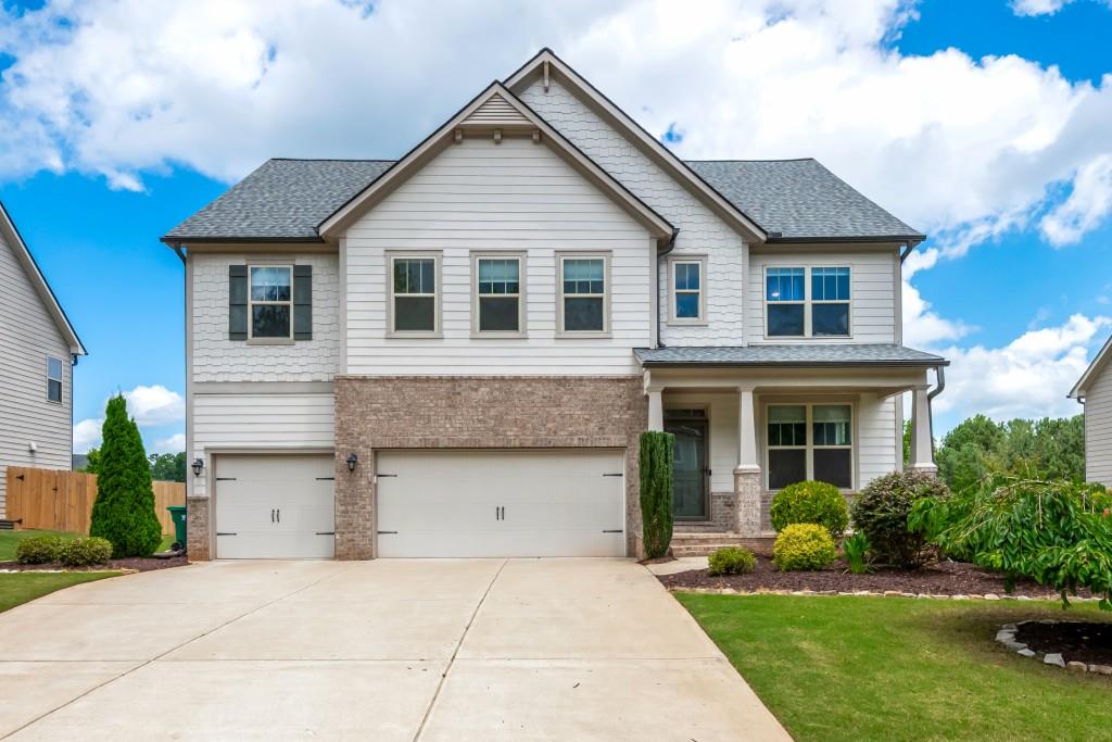 2039 West Hampton Drive Canton, GA 30115 - Photo 1 of 1 a front view of a house with a yard and garage