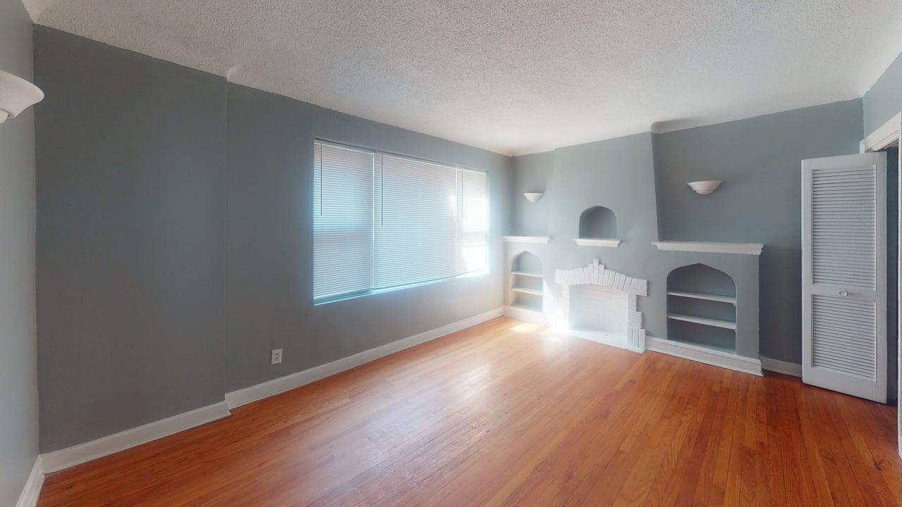 817 West 83rd Street, Unit 2N Chicago, IL 60620 - Photo 1 of 7 a view of empty room with wooden floor and fireplace