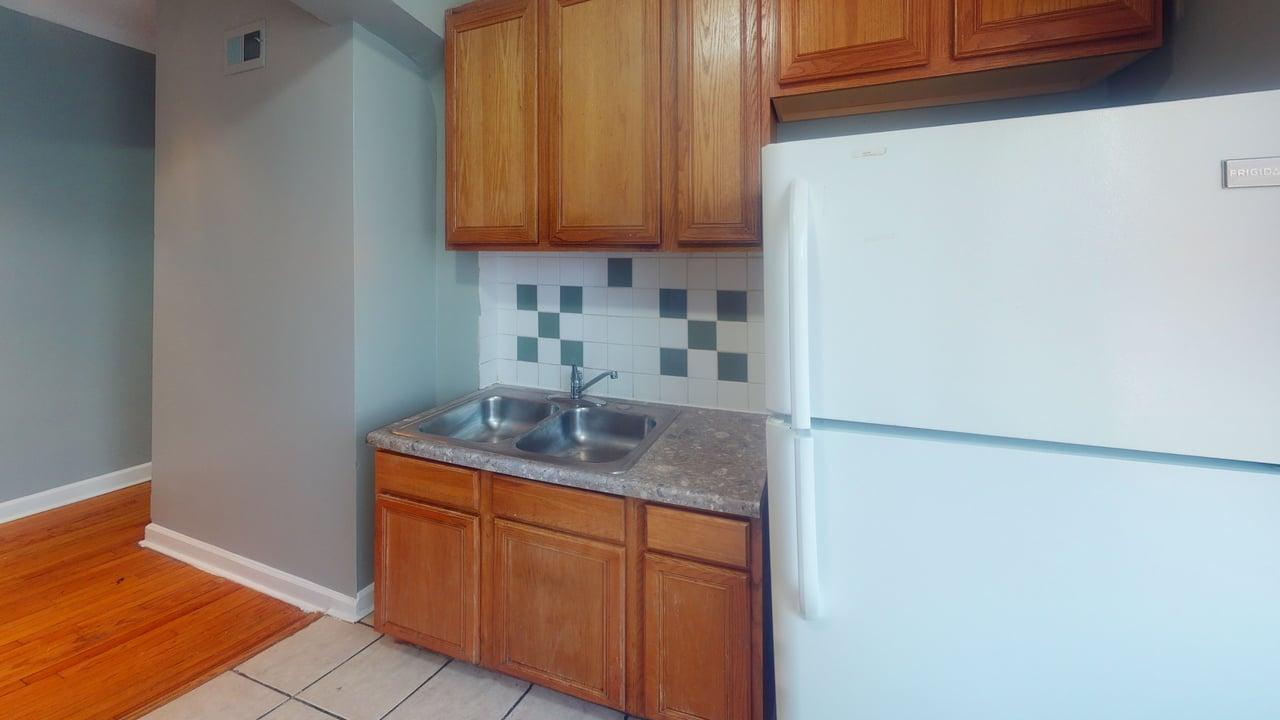 817 West 83rd Street, Unit 2N Chicago, IL 60620 - Photo 4 of 7 a kitchen with stainless steel appliances granite countertop a sink and a cabinets