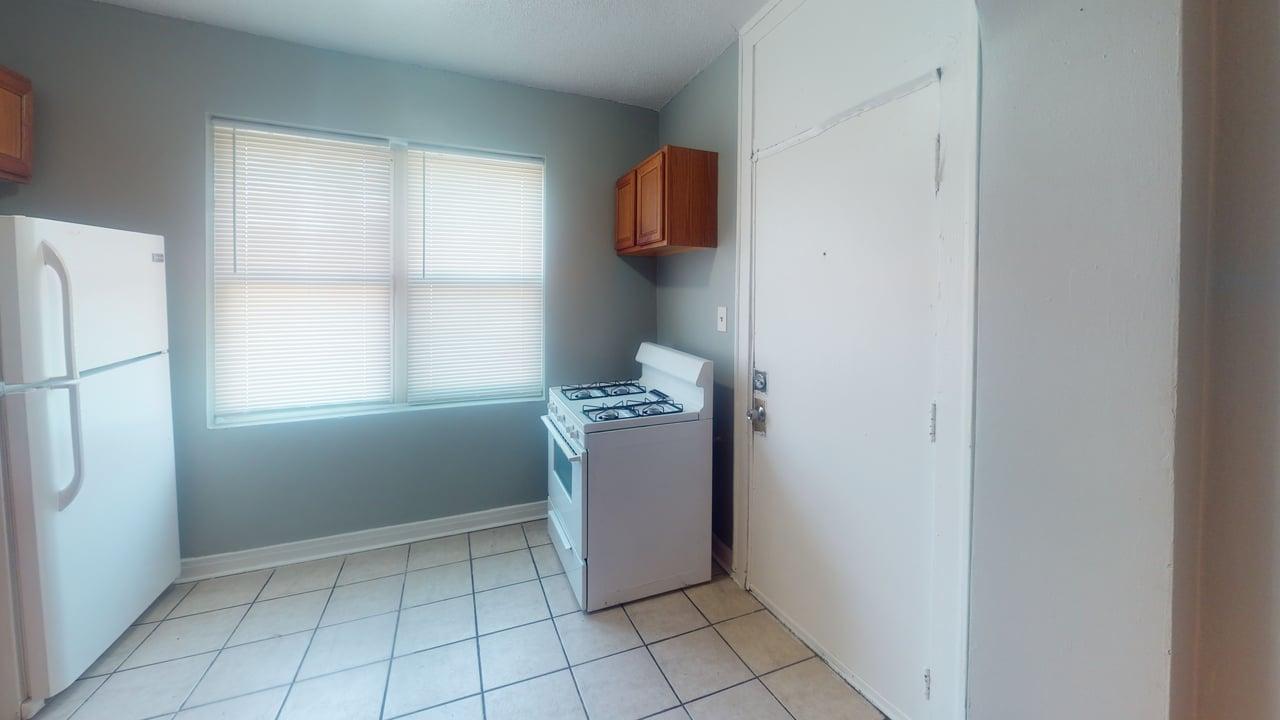 817 West 83rd Street, Unit 2N Chicago, IL 60620 - Photo 5 of 7 a room with a window and a refrigerator