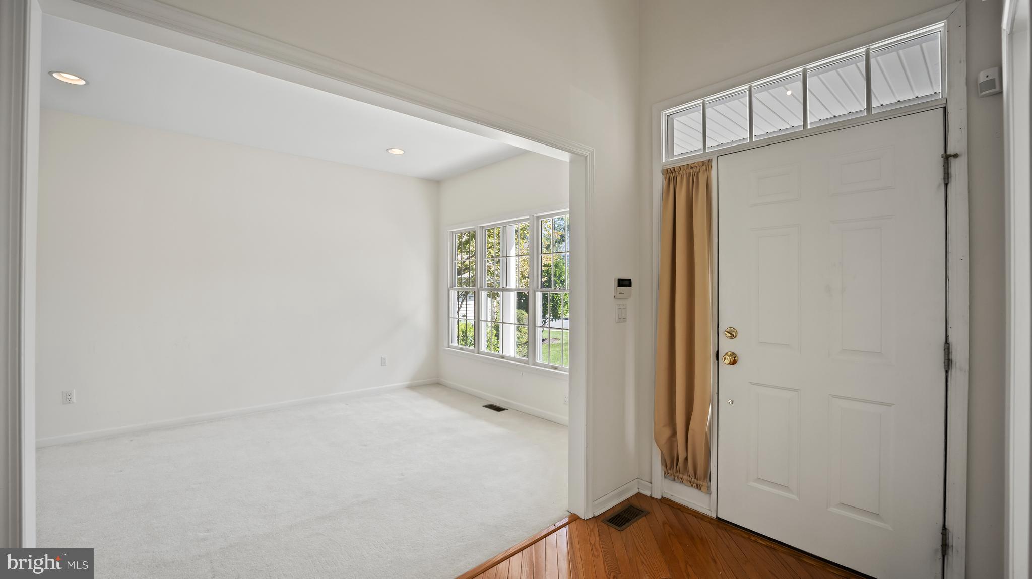 8 Bethpage Drive Skillman, NJ 08558 - Photo 13 of 36 a view of an empty room with wooden floor and a window