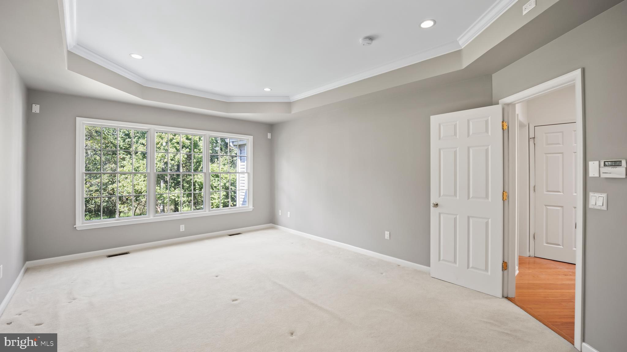 8 Bethpage Drive Skillman, NJ 08558 - Photo 18 of 36 a view of an empty room with wooden floor and a window