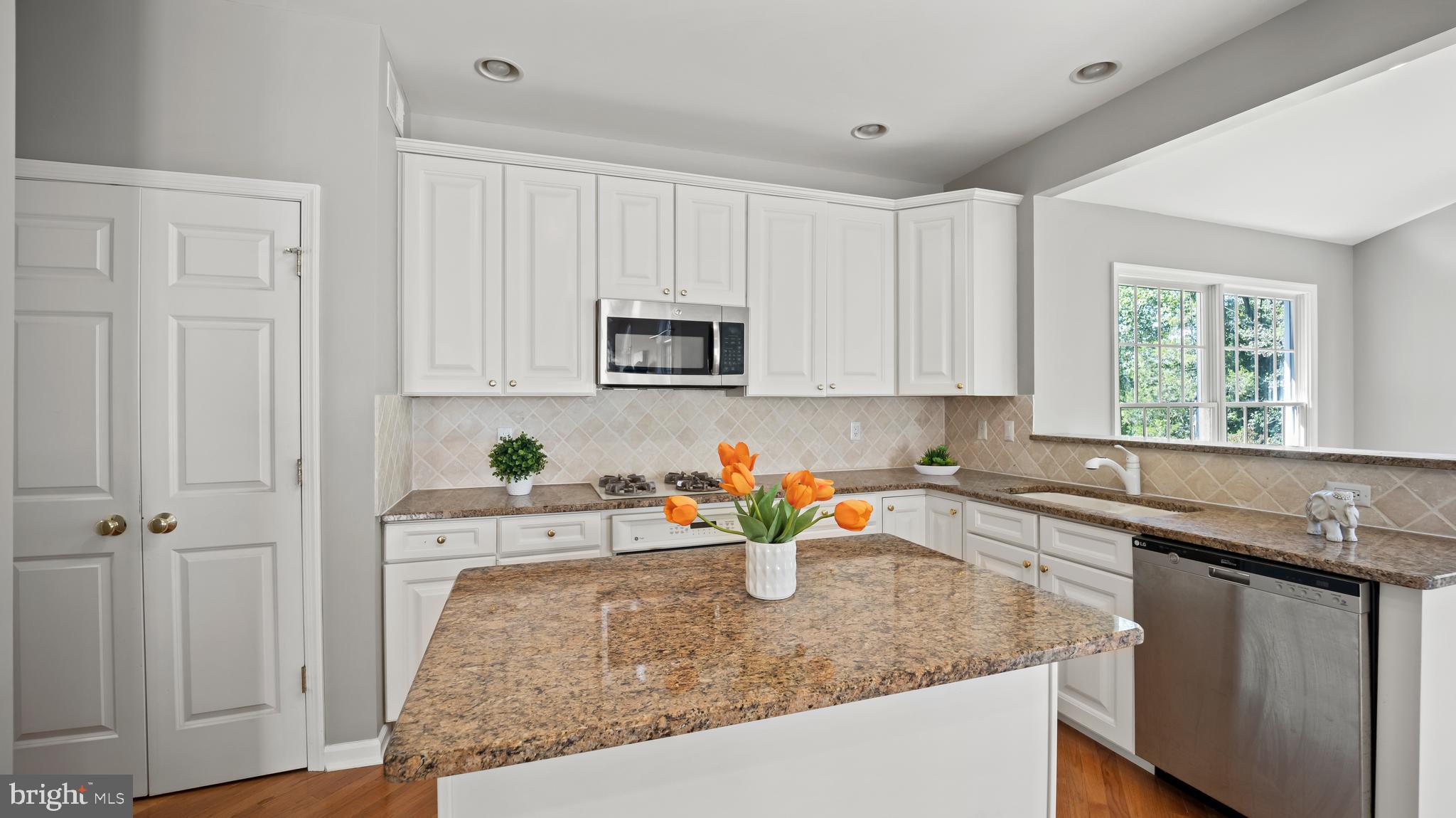8 Bethpage Drive Skillman, NJ 08558 - Photo 7 of 36 a kitchen with stainless steel appliances granite countertop a sink stove and cabinets