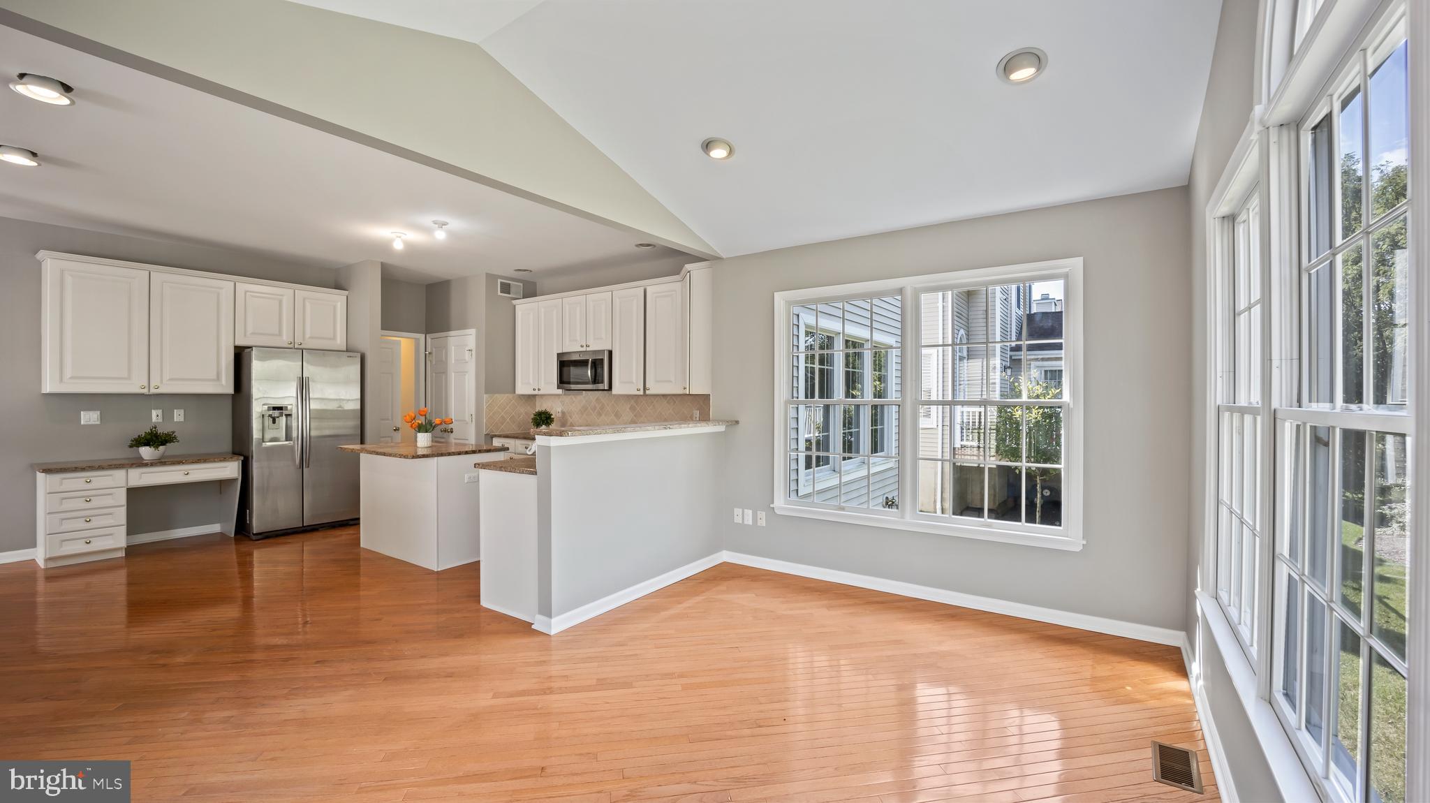 8 Bethpage Drive Skillman, NJ 08558 - Photo 9 of 36 a living room with stainless steel appliances kitchen island granite countertop a refrigerator and cabinets