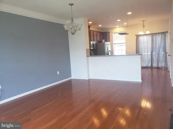 a view of a kitchen with a refrigerator and a chandelier