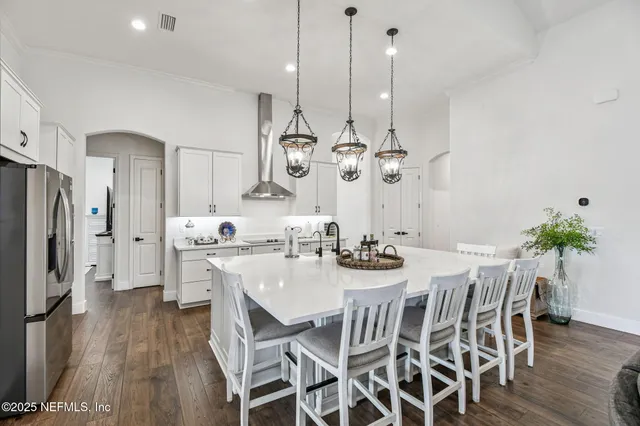 a spacious bathroom with a granite countertop sink a toilet and a mirror