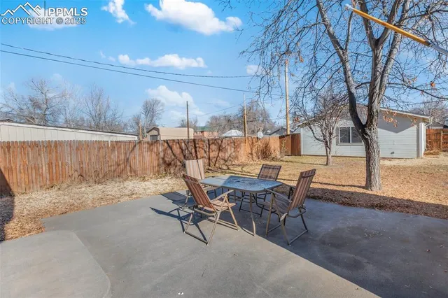 a view of a patio with a table and chairs