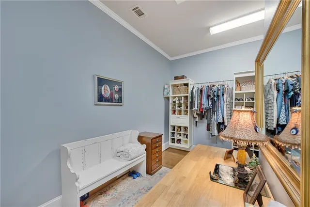 a house that is sitting in the grass with large trees