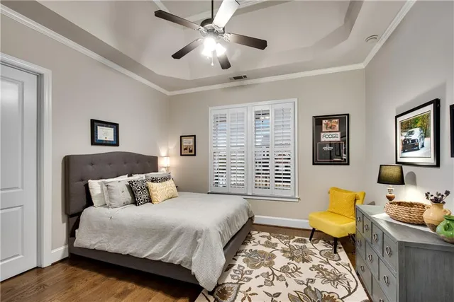 a bedroom with furniture and a large window