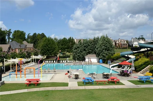 an aerial view of a house with a yard and lake view