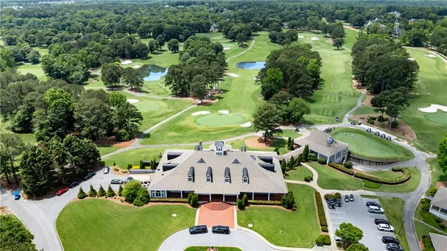 an aerial view of residential houses with outdoor space and trees