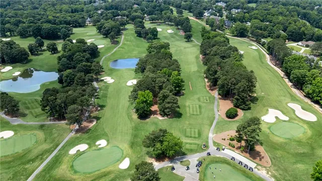 an aerial view of a residential houses with outdoor space and street view