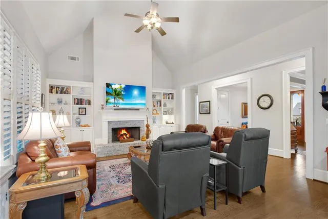 a living room with furniture a fireplace and a flat screen tv