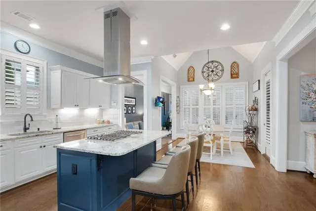 a large kitchen with a table and chairs