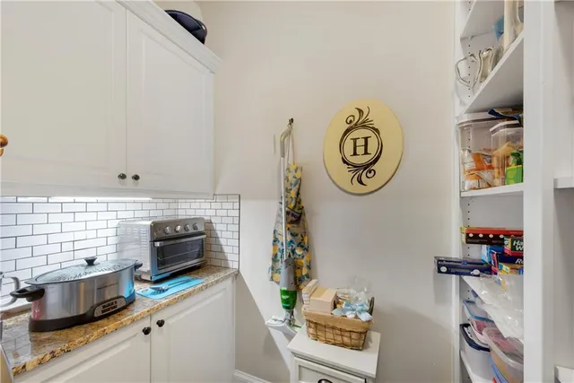 a kitchen with stainless steel appliances granite countertop a sink and a stove
