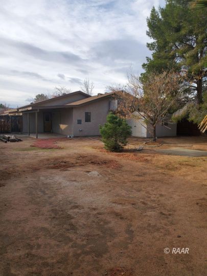 342 East Wilson Avenue Ridgecrest, CA 93555 - Photo 24 of 27 a front view of house with yard and trees