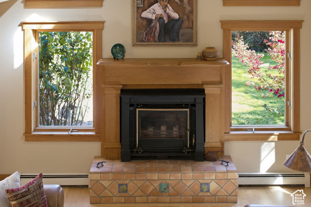 725 Canyon Road Smithfield, UT 84335 - Photo 22 of 100 Wood-finish fireplace surround with a black metal insert, complemented by a tile hearth featuring patterned accents