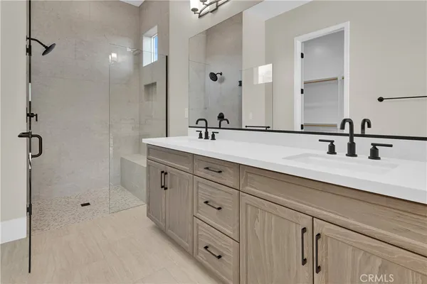 a spacious bathroom with double sink and a mirror