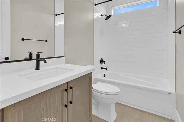 a bathroom with a sink a toilet and a bathtub