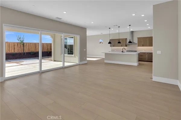 a view of kitchen with kitchen island a sink stainless steel appliances and cabinets