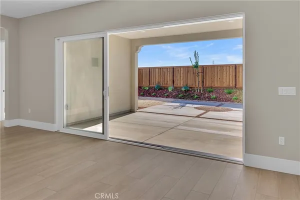 a view of a room with wooden floor and a window