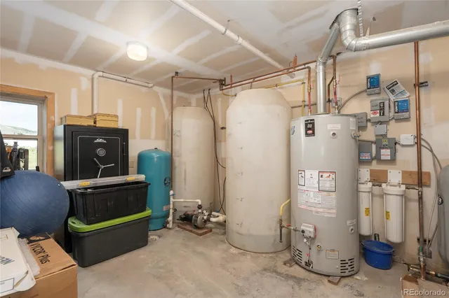 a utility room with refrigerator and washer