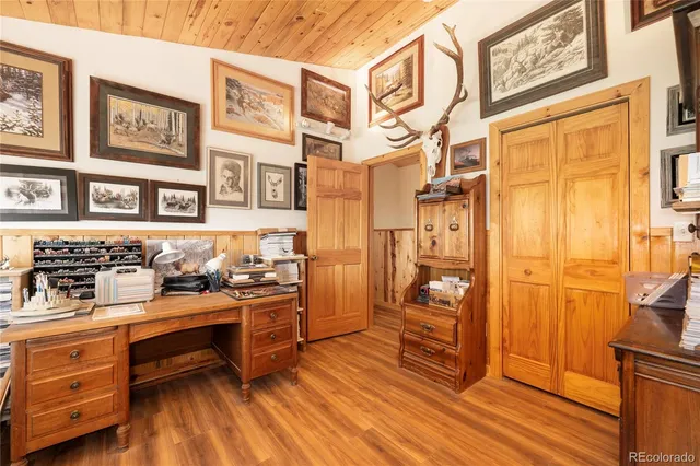 a kitchen view with cabinets and wooden floor