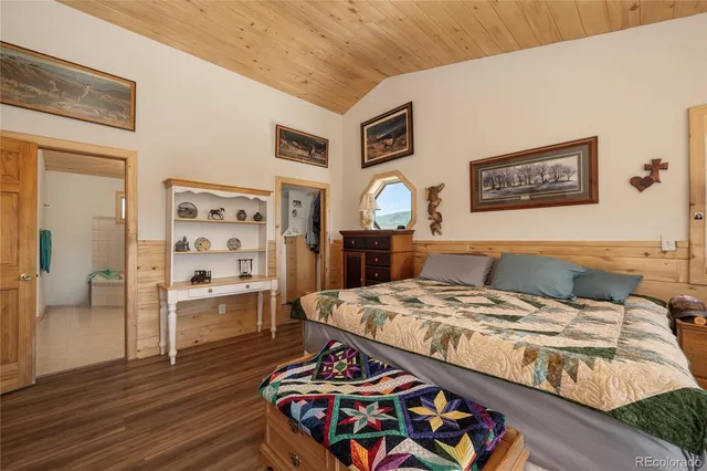 a living room with a bed and dresser