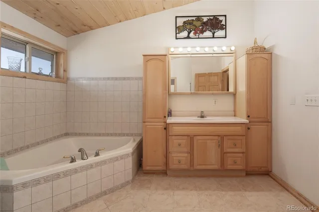 a bathroom with a bathtub sink and a window