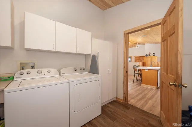 a view of washer and dryer with kitchen in the background