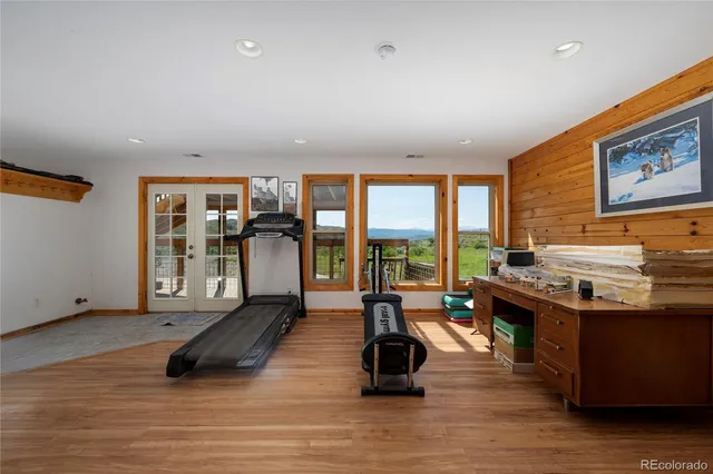 a view of a room with gym equipment and windows