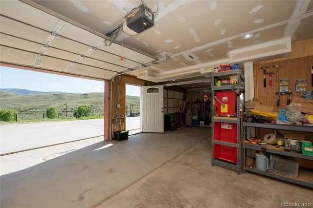 a view of a storage room with air conditioner and a window