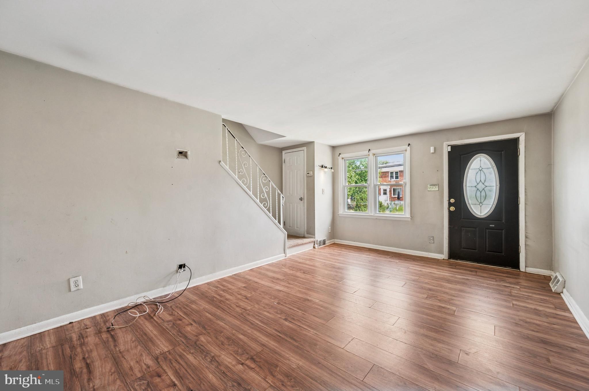 952 Grant Road Folcroft, PA 19032 - Photo 2 of 19 an empty room with wooden floor and windows