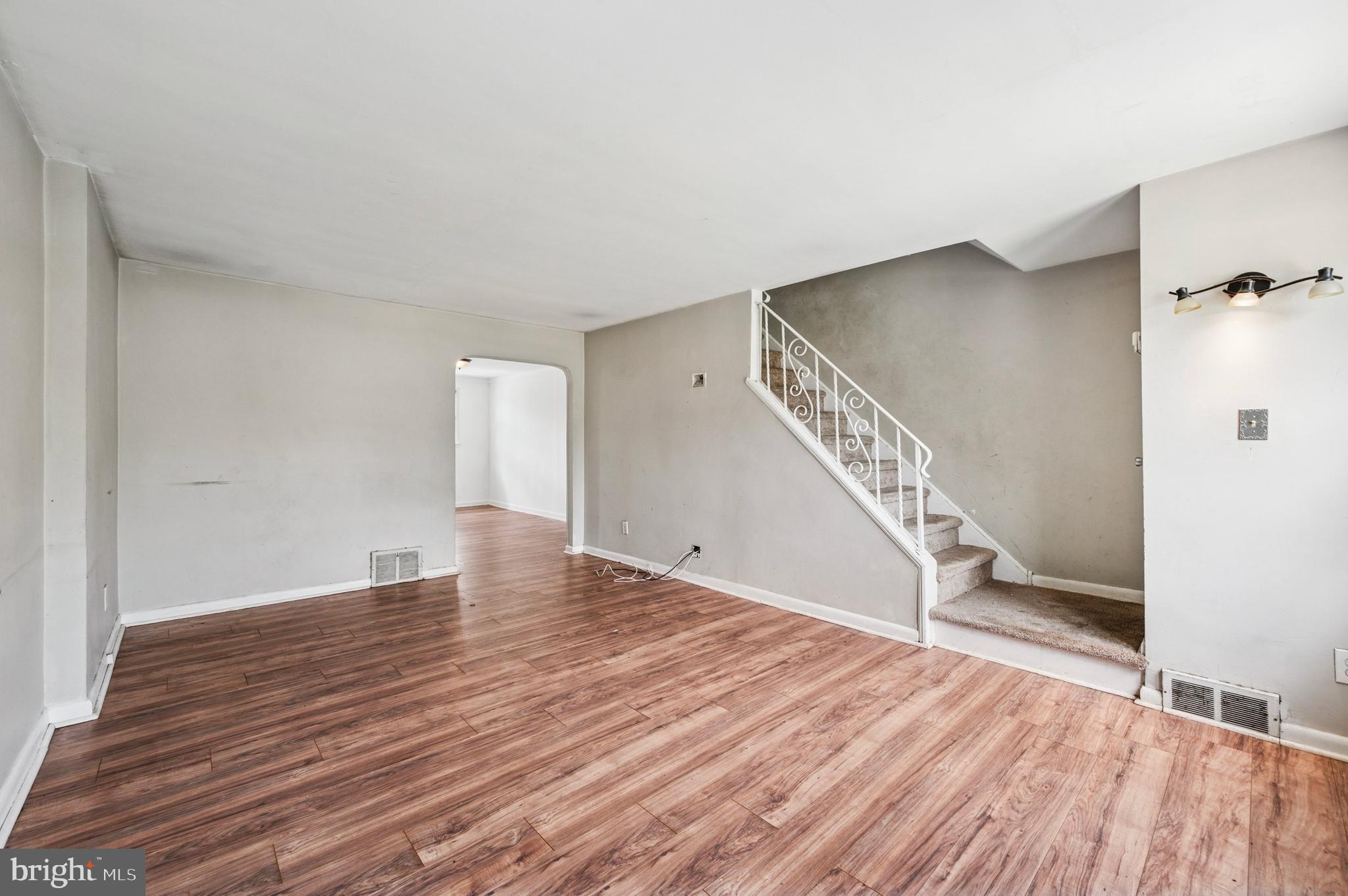 952 Grant Road Folcroft, PA 19032 - Photo 3 of 19 a view of an empty room with wooden floor and stairs