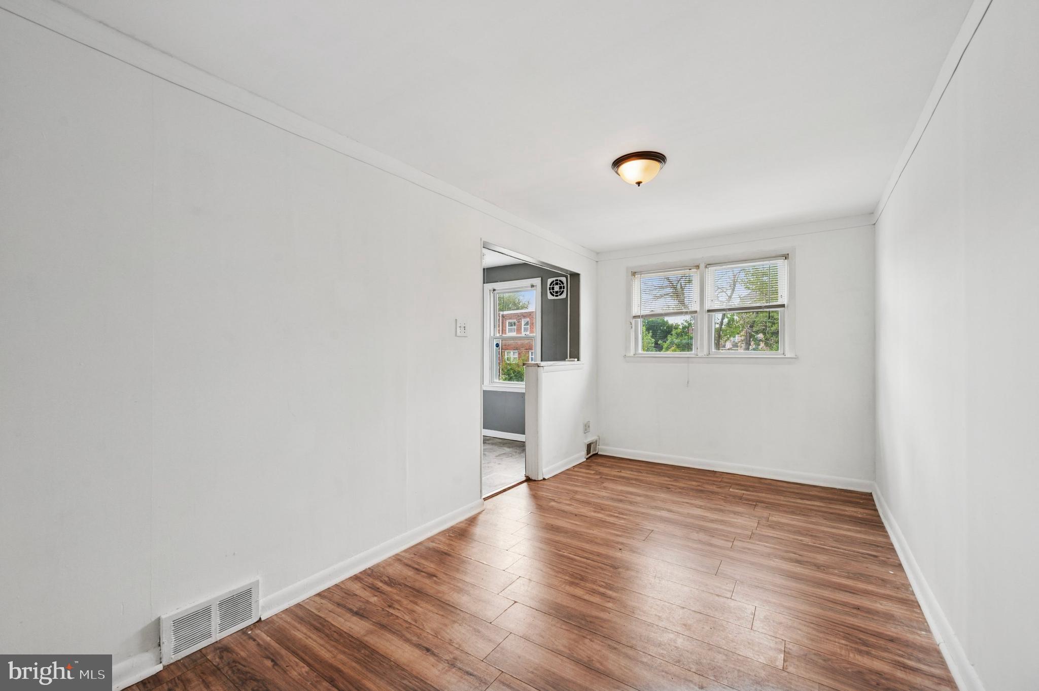 952 Grant Road Folcroft, PA 19032 - Photo 5 of 19 an empty room with wooden floor and a window