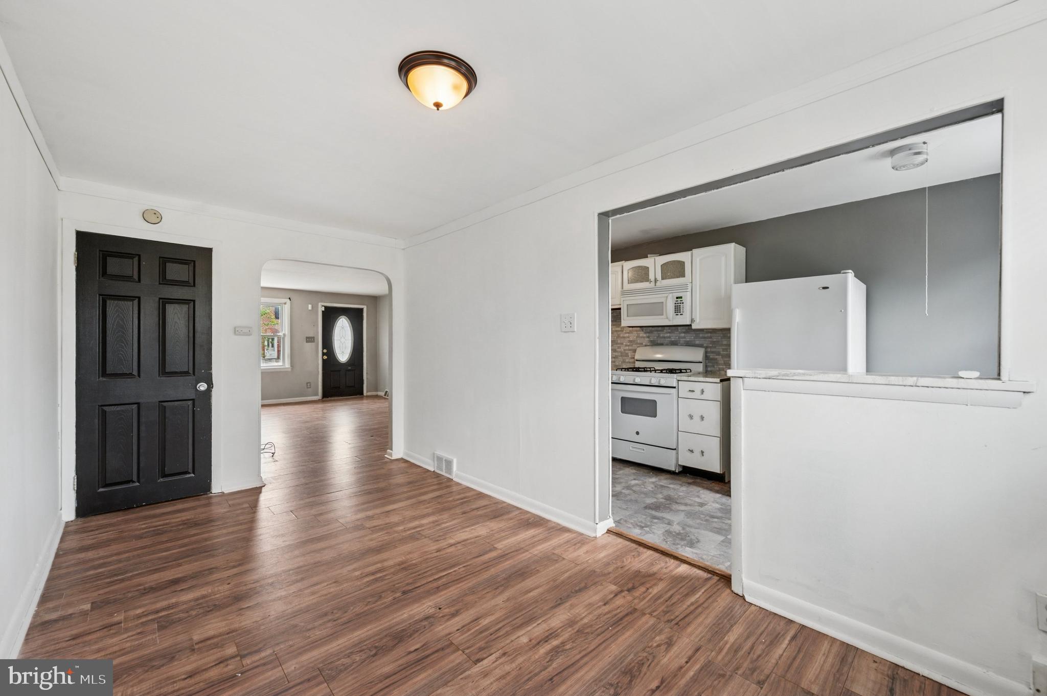952 Grant Road Folcroft, PA 19032 - Photo 6 of 19 a view of a hallway with wooden floor and a kitchen