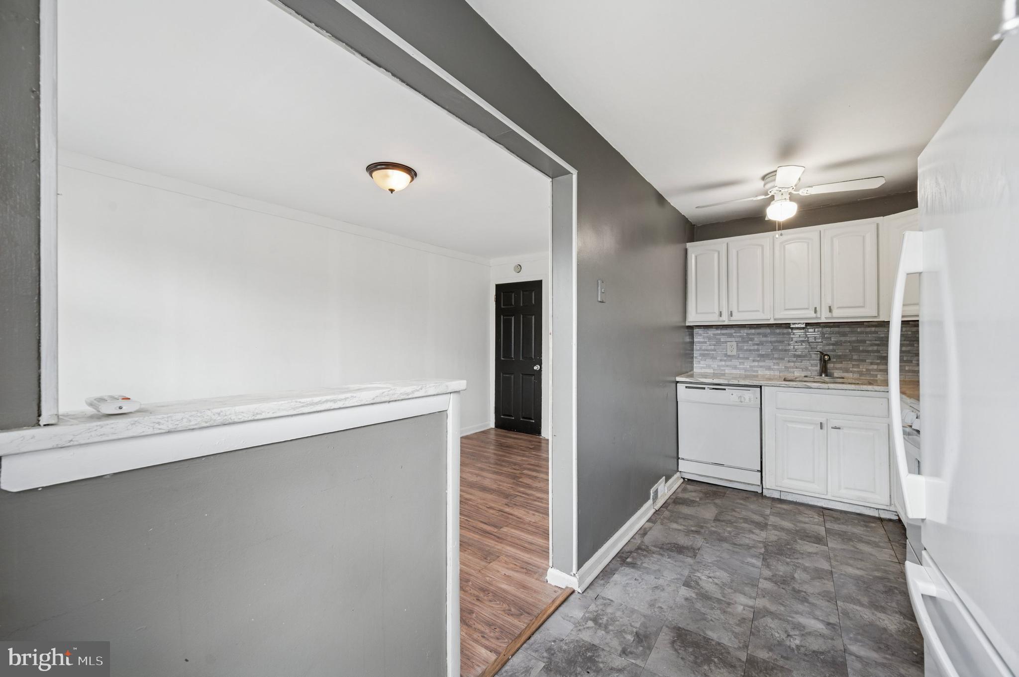 952 Grant Road Folcroft, PA 19032 - Photo 7 of 19 a kitchen with cabinets and wooden floor