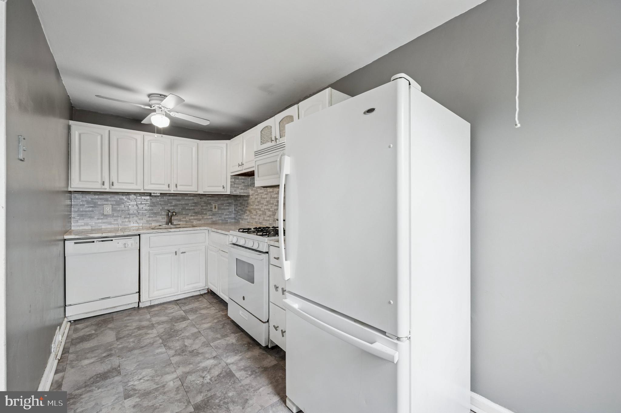 952 Grant Road Folcroft, PA 19032 - Photo 8 of 19 a kitchen with refrigerator cabinets and a sink