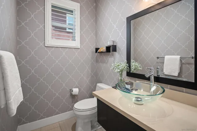 a bathroom with a sink a toilet and a mirror