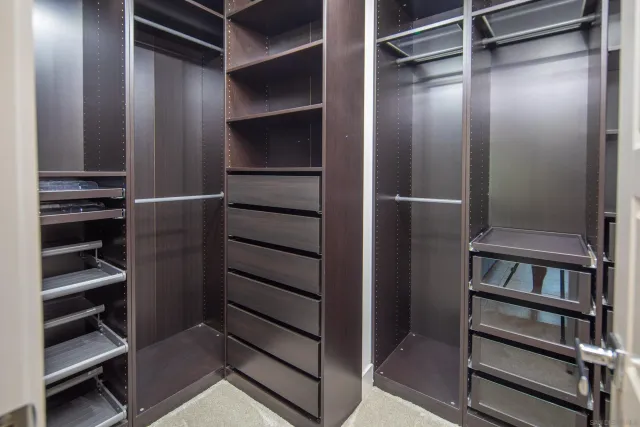 a view of walk in closet with empty racks