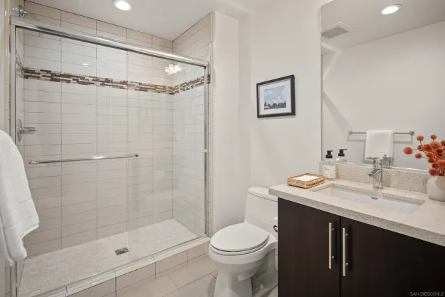 a bathroom with a sink a toilet and shower